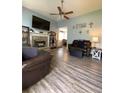 Inviting living space with modern flooring, stone fireplace, and vaulted ceilings at 305 Pleasant Forest Dr, Temple, GA 30179