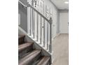 Carpeted staircase with white railing and spindles leading to the upper level with access to several rooms at 4643 Grand Central Pkwy, Decatur, GA 30035