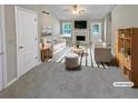 Bright, staged living room with fireplace, large windows, and comfortable furniture at 3510 Beaver Cove Rd, Cumming, GA 30041