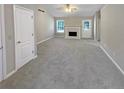 Bright living room with fireplace, large windows, and neutral walls at 3510 Beaver Cove Rd, Cumming, GA 30041