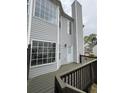 Back porch with railing and gray siding on townhome at 1703 Feast Ct, Cumming, GA 30040