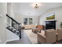 Bright living room featuring neutral-toned walls, vinyl floors, a black fireplace, and a staircase at 1703 Laurel Creek Cir, Lithonia, GA 30058