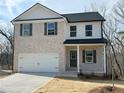 Charming two-story home featuring a brick facade, black shutters, and a two-car garage at 18 Loth Wages (Lot 18) Rd, Dacula, GA 30019