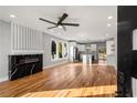 Bright, open living space with fireplace, modern ceiling fan, hardwood floors, and seamless flow to the kitchen at 221 Silver Springs Sw Cir, Atlanta, GA 30310
