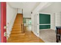 Inviting foyer with hardwood floors, a staircase, and an adjacent room with elegant French doors at 3200 Country Club Nw Ct, Kennesaw, GA 30144