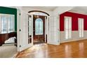 Bright foyer featuring hardwood floors and a decorative front door with sidelight windows at 3200 Country Club Nw Ct, Kennesaw, GA 30144