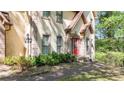 Charming home exterior showcasing a well-manicured front yard and a vibrant red front door at 3200 Country Club Nw Ct, Kennesaw, GA 30144