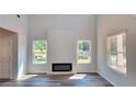 Spacious living room featuring an electric fireplace and lots of natural light at 2 Loth Wages (Lot 2) Rd, Dacula, GA 30019