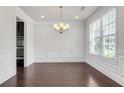 Formal dining area with hardwood floors, picture-frame molding, chandelier, and natural light at 1645 Dahlia Dr, Cumming, GA 30040