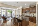 Open concept kitchen with dark wood cabinetry, granite countertops, and seating at the island at 25 High Gate Trail, Atlanta, GA 30030