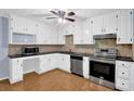 Bright kitchen featuring white cabinets, stainless steel appliances, and granite countertops at 3090 Thrasher Nw Ct, Kennesaw, GA 30144