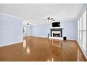 Spacious living room featuring hardwood floors, a fireplace, and ample natural light at 3090 Thrasher Nw Ct, Kennesaw, GA 30144