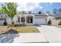 Inviting home showcasing a columned front porch, a two-car garage, and landscaped front yard at 460 Marston Pass, Acworth, GA 30102