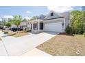 Beautiful single-Gathering home with a spacious driveway, attached two-car garage, and inviting front porch at 460 Marston Pass, Acworth, GA 30102