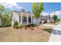 Attractive home with a charming front porch, a well-kept lawn, and an attached two-car garage at 460 Marston Pass, Acworth, GA 30102