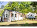 Charming single-story home featuring white siding, a cozy front yard, and a classic American flag at 2086 Harold Se Ave, Smyrna, GA 30080