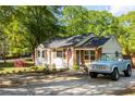 Beautiful one-story home featuring white siding, decorative shutters, and lush, green landscaping at 2086 Harold Se Ave, Smyrna, GA 30080