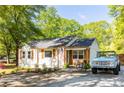 Renovated cottage-style home features a new roof, a classic car, and a gravel driveway at 2086 Harold Se Ave, Smyrna, GA 30080