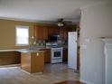 Functional kitchen with light wood cabinets, appliances, and a breakfast bar at 4909 Farm Valley Ne Dr, Woodstock, GA 30188