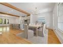 Open dining room features a modern chandelier and is adjacent to the kitchen and breakfast bar seating at 9062 Selborne Ln, Palmetto, GA 30268