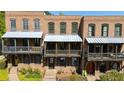 Brick townhouses with covered front porches, offering classic curb appeal at 9062 Selborne Ln, Palmetto, GA 30268