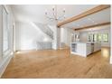 Bright, open-concept living space with hardwood floors and modern lighting at 9062 Selborne Ln, Palmetto, GA 30268