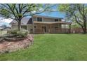 Spacious backyard with a covered patio and a lush green lawn, perfect for outdoor living at 115 Braided Blanket Blf, Johns Creek, GA 30022