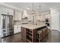 Gourmet kitchen boasts stainless steel appliances, granite countertops, and a large center island with seating at 2005 Etris Manor Dr, Roswell, GA 30075
