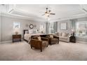 Spacious main bedroom with a tray ceiling, sitting area, and abundant natural light from large windows at 2005 Etris Manor Dr, Roswell, GA 30075