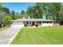 Traditional home featuring a spacious front lawn and attached two-car garage at 4284 Carlos Ct, Powder Springs, GA 30127
