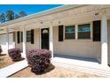 Close-up of the front porch with a black front door and black window shutters at 4284 Carlos Ct, Powder Springs, GA 30127