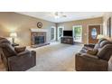 Bright living room featuring a stone fireplace and large windows for natural light at 6865 Fletcher Dr, Winston, GA 30187