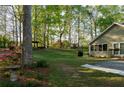 Expansive backyard with lush greenery, mature trees, and a wooded view at 2380 Emerald Dr, Loganville, GA 30052