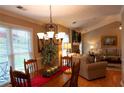 Dining room with a chandelier, wainscoting, and views of the living room at 2380 Emerald Dr, Loganville, GA 30052