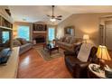 Inviting living room with a brick fireplace, ceiling fan, and comfortable seating at 2380 Emerald Dr, Loganville, GA 30052