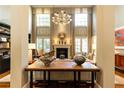 Bright living room with a soaring ceiling, fireplace, and large windows overlooking the yard at 5178 S Trimble Rd, Atlanta, GA 30342