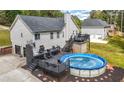 Backyard deck, above ground pool, and detached garage with additional storage space at 127 Pebblebrook Way, Temple, GA 30179