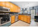Modern kitchen featuring wooden cabinets, stainless steel appliances, and backsplash at 127 Pebblebrook Way, Temple, GA 30179