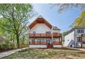 Beautiful two-story modern farmhouse with spacious wood balconies and well-kept lawn at 1882 Francis Nw Ave, Atlanta, GA 30318