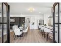 Bright living room features sleek fireplace, dining area, and open kitchen layout at 1882 Francis Nw Ave, Atlanta, GA 30318