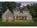 Twilight view of a charming two-story home with a welcoming front porch and well-manicured lawn at 284 Hook St, Alpharetta, GA 30009