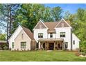 Striking exterior showcasing a two-story home with a manicured lawn, and brick-and-siding design at 284 Hook St, Alpharetta, GA 30009