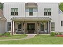 Inviting front porch features classic rocking chairs and hanging plants, perfect for enjoying the outdoors at 284 Hook St, Alpharetta, GA 30009