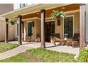 Inviting front porch features rocking chairs, brick flooring, wood columns, and hanging plants at 284 Hook St, Alpharetta, GA 30009