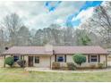 Charming single-story home with a well-maintained lawn and neutral-colored siding and brown trim at 133 Dailey Mill Rd, Mcdonough, GA 30253