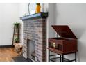 Close-up view of a brick fireplace with mantle and decorative items at 1518 Langston Sw Ave, Atlanta, GA 30310
