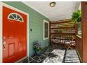 Inviting front porch with a stone floor, seating area, and a vibrant red front door at 1518 Langston Sw Ave, Atlanta, GA 30310