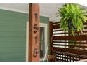 Close-up of the house number and a decorative fern on the front porch, adding character and curb appeal at 1518 Langston Sw Ave, Atlanta, GA 30310