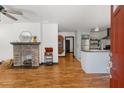 Open concept living space with hardwood floors, a brick fireplace, and seamless flow to the kitchen at 1518 Langston Sw Ave, Atlanta, GA 30310