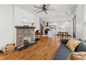 Open living space featuring hardwood floors, brick fireplace, and access to the kitchen at 1518 Langston Sw Ave, Atlanta, GA 30310